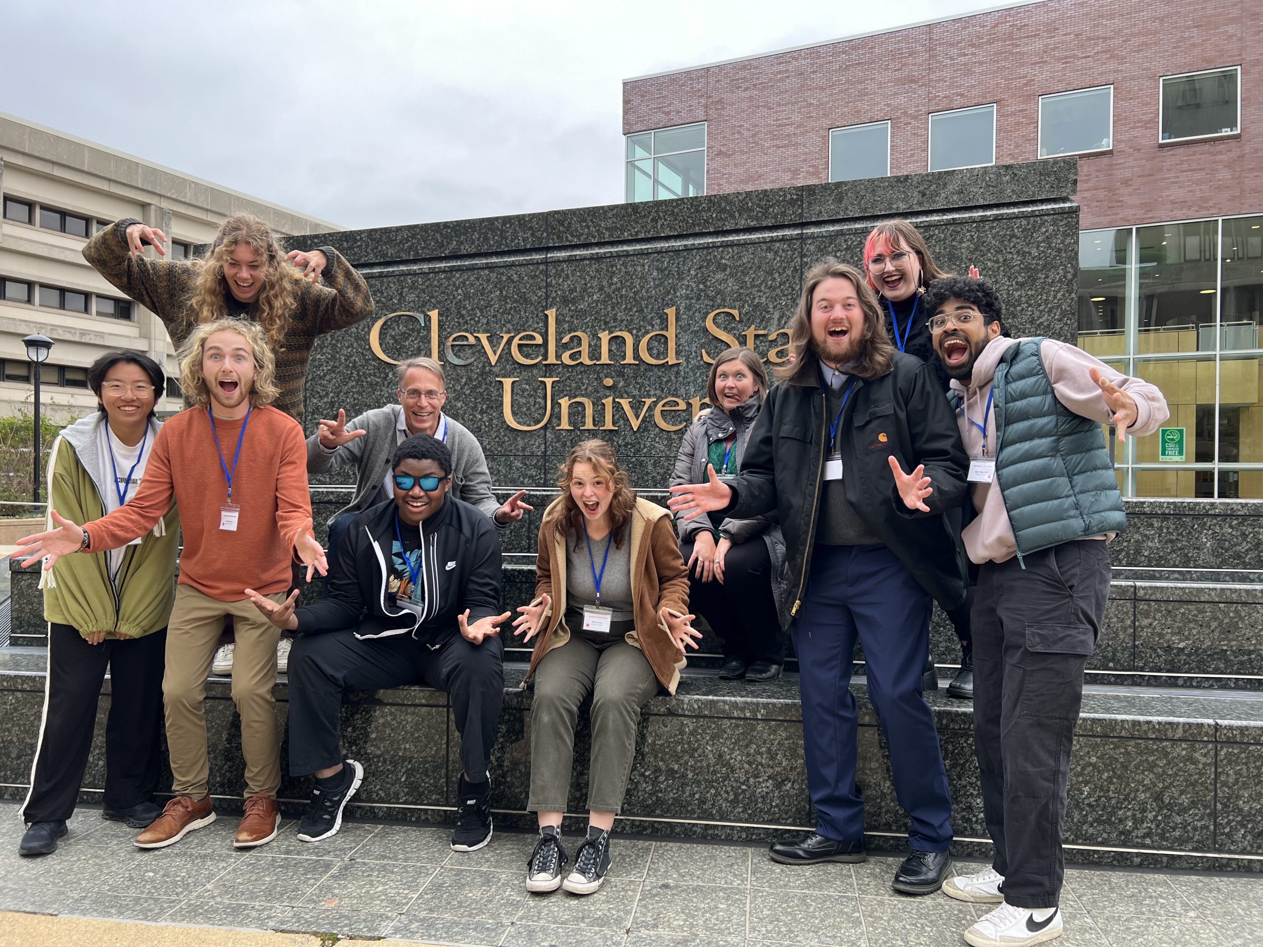 A group of students in front of a sign for Cleveland State University